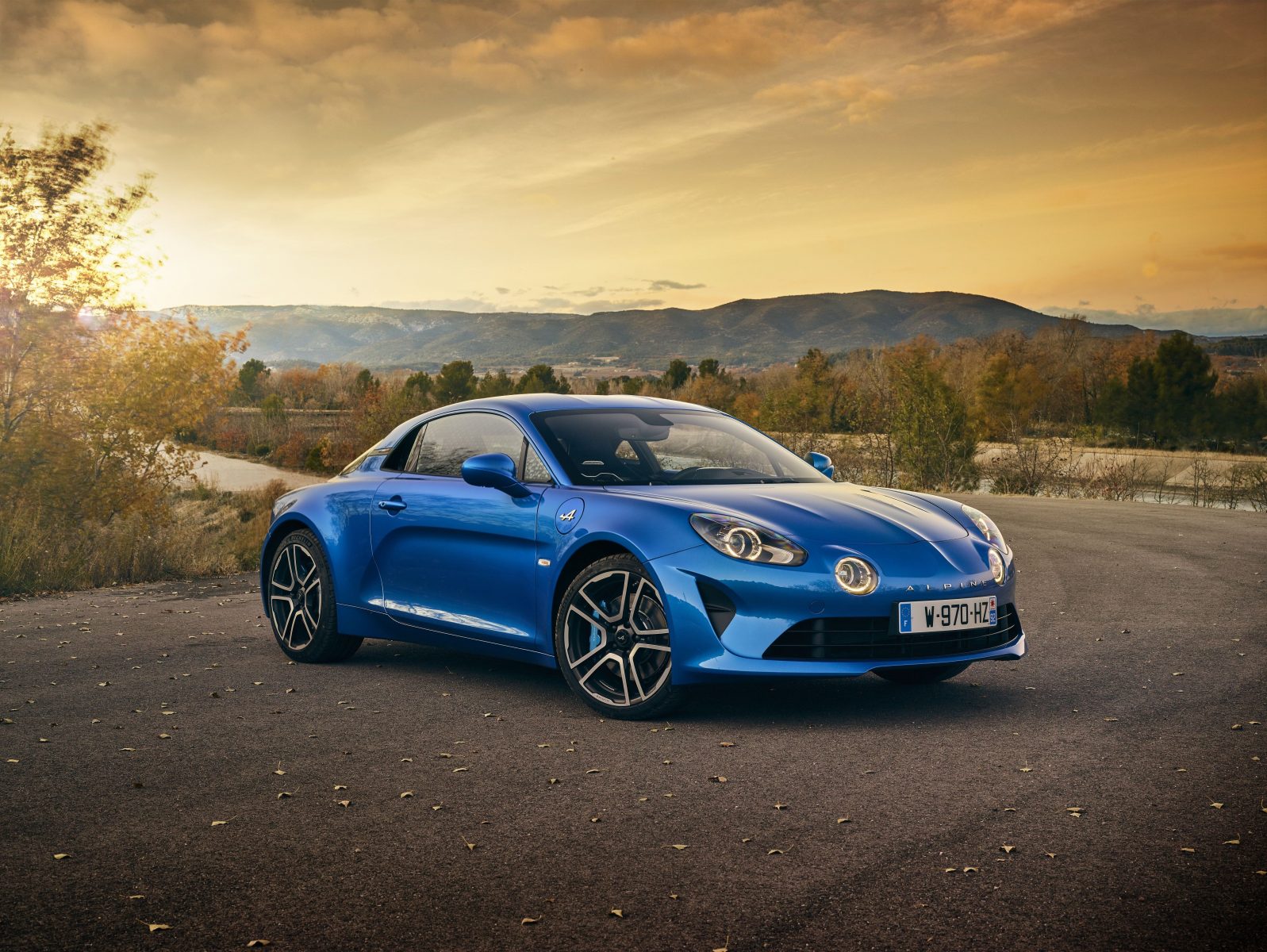 Alpine A110 in Blue with scenic backdrop